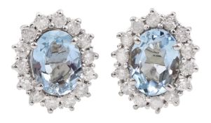 Pair of 18ct white gold oval aquamarine and round brilliant cut diamond cluster stud earrings