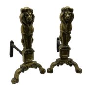 Pair of cast brass fire dogs in the form of upright lions