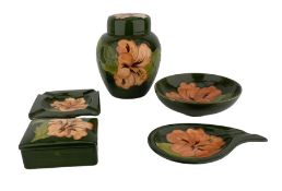Moorcroft pottery Hibiscus pattern ginger jar and cover on a green ground with printed paper label '
