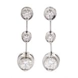 Pair of 18ct white gold graduating three stone round brilliant cut diamond pendant earrings