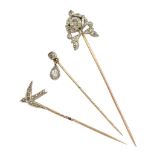 Three Victorian silver and gold diamond stick pins including swallow and an old cut diamond with pe