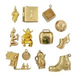 Twelve 9ct gold pendant/charms including Viking troll