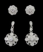 Pair of silver cubic zirconia flower cluster pendant earrings and a similar pair of stud earrings