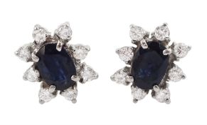Pair of 18ct gold oval sapphire and round brilliant cut diamond cluster stud earrings