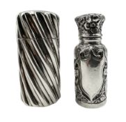 Victorian silver cylindrical scent flask of spiral design with hinged cover and interior glass stopp