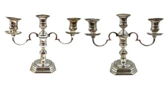 Pair of silver three branch table candelabra with scroll branches and on octagonal bases H21cm Birmi