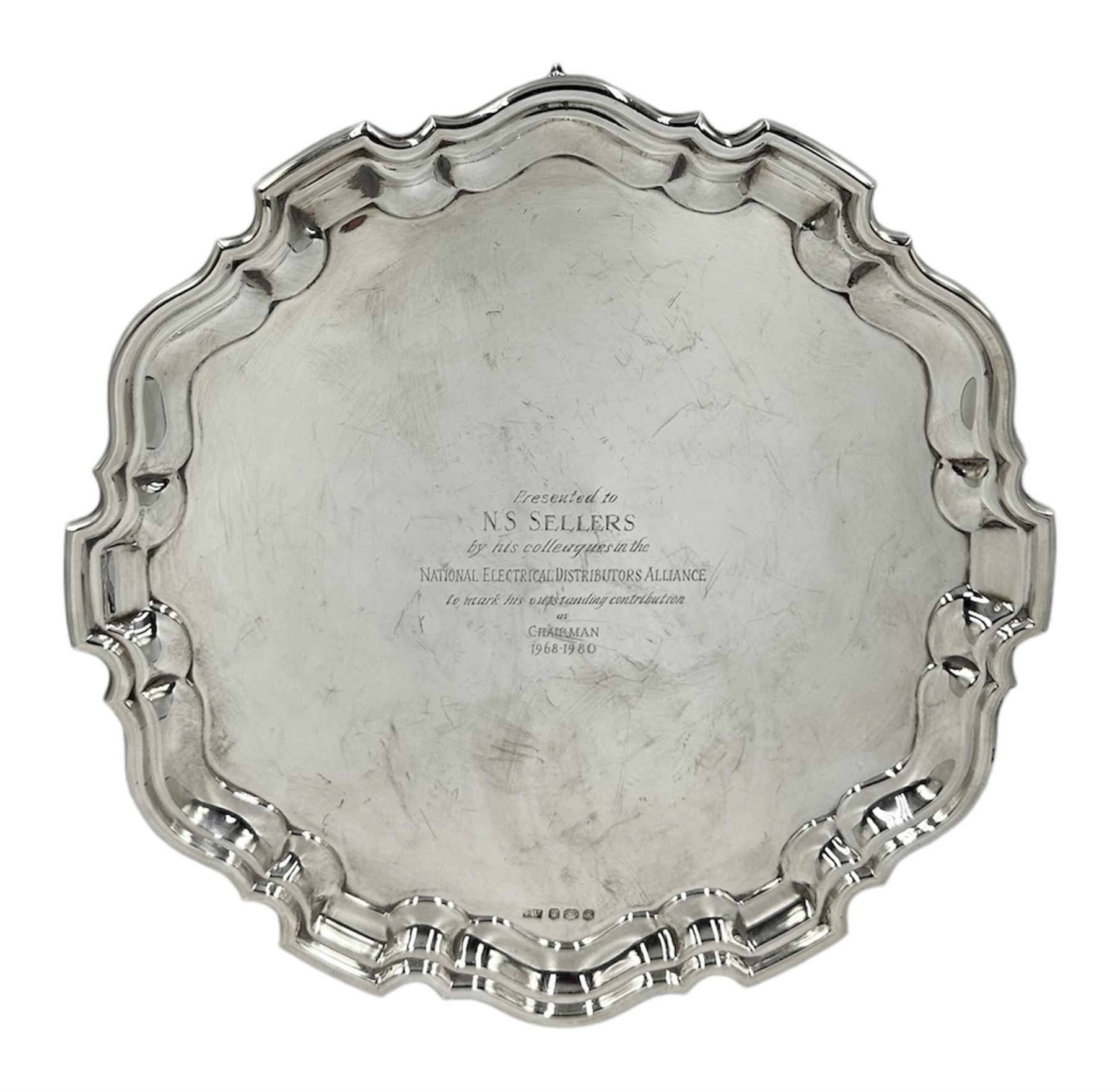 Silver circular salver with moulded edge and scroll feet with presentation inscription and a list of