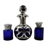 Edwardian blue glass small scent flask of facet cut design with hinged silver cover and interior gla
