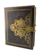 Victorian stamped leather photograph album with cut brass mounts and clasp containing portrait photo