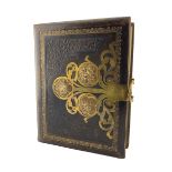 Victorian stamped leather photograph album with cut brass mounts and clasp containing portrait photo