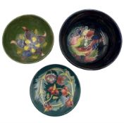 Three pieces of Moorcroft to include a William Moorcroft Leaf and Berries pattern bowl on blue groun