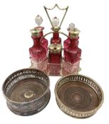 Early 20th century silver-plated cruet set with six cranberry glass bottles