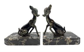 Pair of Art Deco style patinated spelter bookends cast as fawns on marbled bases