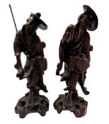 Pair of Chinese carved standing figures of farmers on rockwork bases H30cm