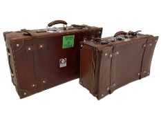 Graduating pair mid-20th century leather suitcases