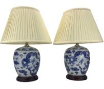 Pair of blue and white ovoid form table lamps