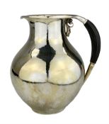 Georg Jensen silver water pitcher of baluster form with spot hammered decoration and ebony handle