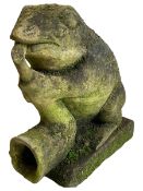 Weathered stone figure of a frog playing the saxophone