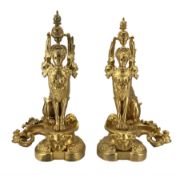 Pair of ornate gilt metal fire dogs in the form of Sphinxes