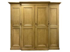 Late 19th century scumbled pine breakfront triple wardrobe or housekeepers cupboard