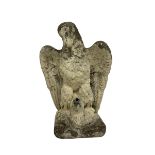 Composite stone garden ornament or water feature in the form of an eagle clutching a fish in its tal