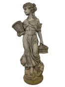 Composite stone garden figure modelled as an Italian maiden carrying baskets