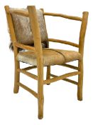 Rustic lightwood framed armchair with hide cover