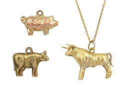 Gold Taurus bull pendant necklace and two cow and pig pendant/charms