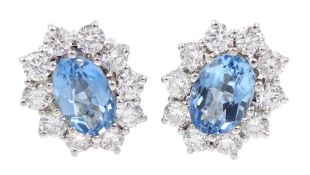 Pair of 18ct white gold oval aquamarine and round brilliant cut diamond cluster stud earrings