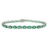 18ct white gold oval cut emerald and round brilliant cut diamond bracelet