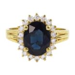 18ct gold oval cut sapphire and round brilliant cut diamond cluster ring