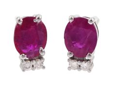 Pair of 18ct white gold oval ruby and diamond stud earrings