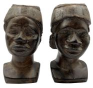 Pair of African carved iron wood male heads each wearing a Kofia cap H18cm