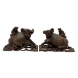 Pair of late 19th century Chinese carved recumbent water buffalo each with a boy on its back and on