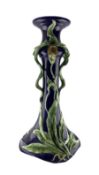 20th century majolica jardiniere stand with trailing leaves on a blue ground H69cm