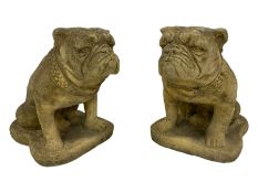 Pair of composite stone garden ornaments in the form of seated British Bulldogs
