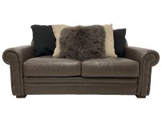 Tetrad - two seat sofa upholstered in brown leather with contrasting scatter cushions