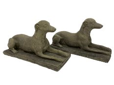 Pair of cast stone garden statues in the form of recumbent greyhounds