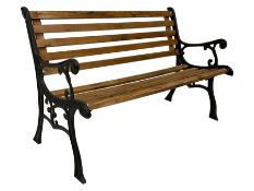 Black painted cast iron and wood slated garden bench