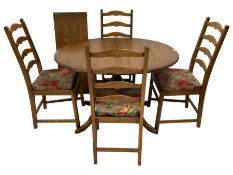 Ercol - elm oval extending dining table with additional leaf