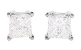 Pair of white gold princess cut diamond stud earrings