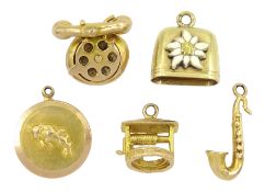 Four 9ct gold pendant /charms including telephone