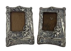 Pair of Edwardian silver photograph frames embossed with a scene from Longfellows Hiawatha with a kn