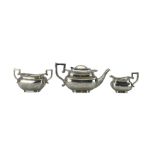 Edwardian silver three piece tea set of rectangular design with gadrooned border and leaf capped ang