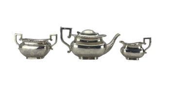 Edwardian silver three piece tea set of rectangular design with gadrooned border and leaf capped ang