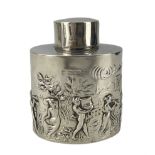 Edwardian silver tea caddy of oval form embossed with a procession of musicians