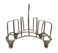 George III silver six division toast rack with loop handle and of undulating outline on four shaped