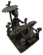 Nigerian Benin bronze group depicting a seated Oba eating under a parasol