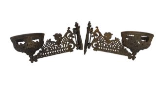 Pair of Victorian cast metal wall sconces with basket shape ends and scroll and female head branches