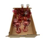 Pair of continental cranberry glass decanters with five matching wine glasses